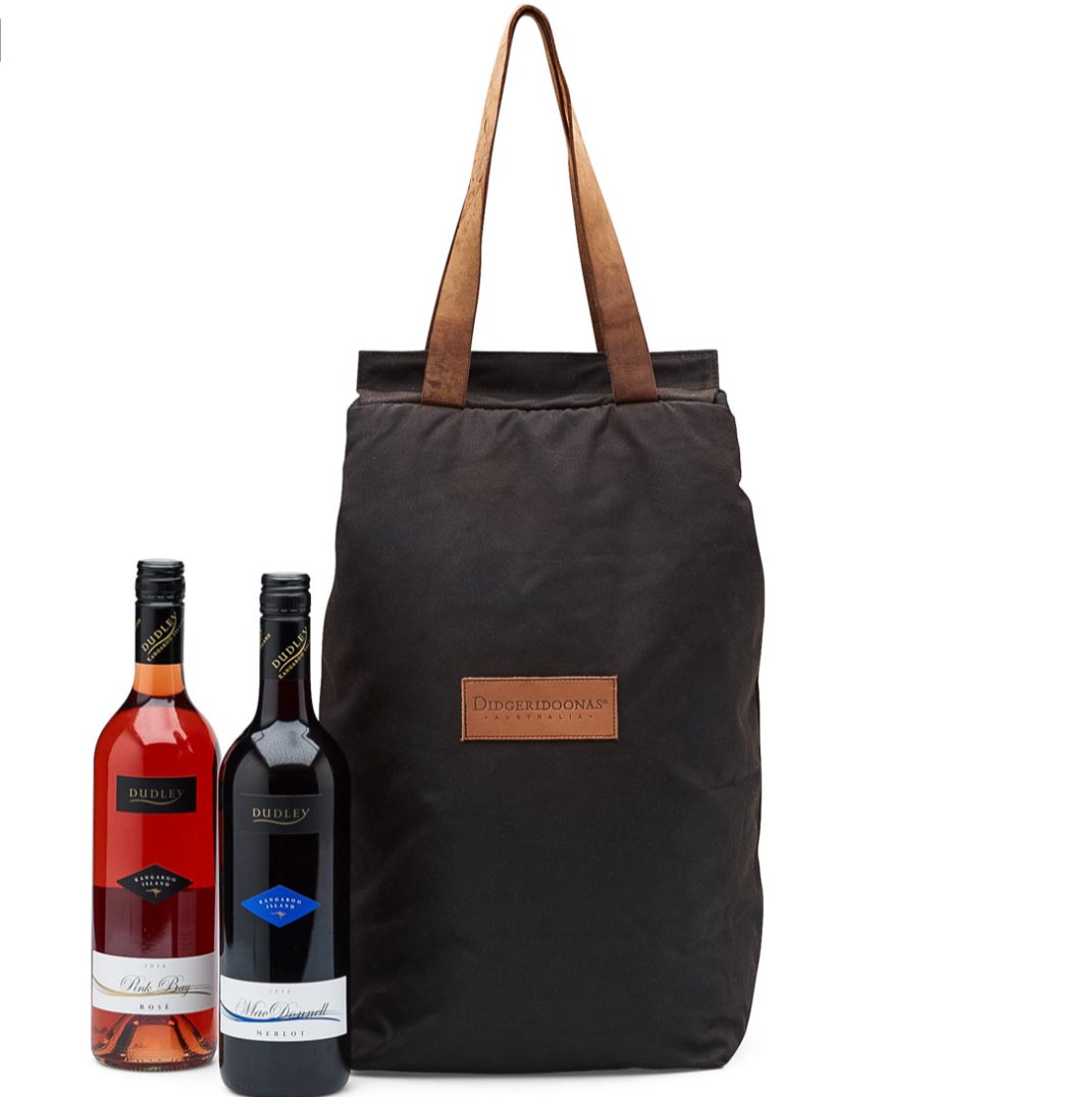 An insulated cooler bag with two leather handles, designed to carry wine bottles. The bag is black, and it is shown alongside two wine bottles with labels.