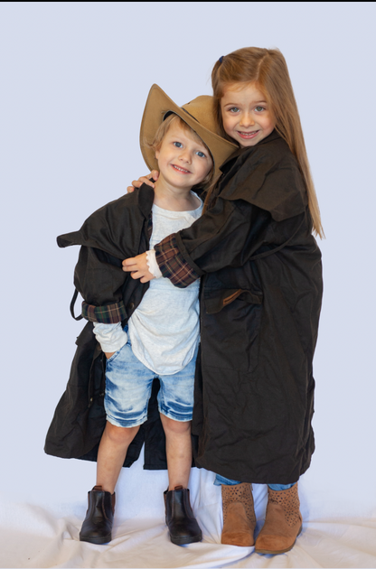 two children showcasing the full length oilskin coat - countryside gear