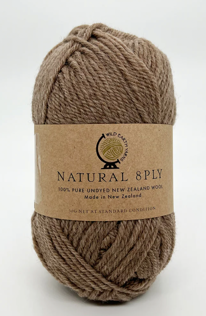 A skein of Natural 8 Ply undyed New Zealand wool in a walnut color, with a label displaying the brand and fiber content.