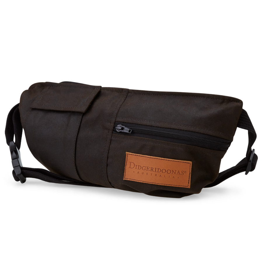 A dark brown waxed canvas fanny pack with a brown leather brand patch. The bag features a front zippered pocket and a side flap, shown on a clean white background.