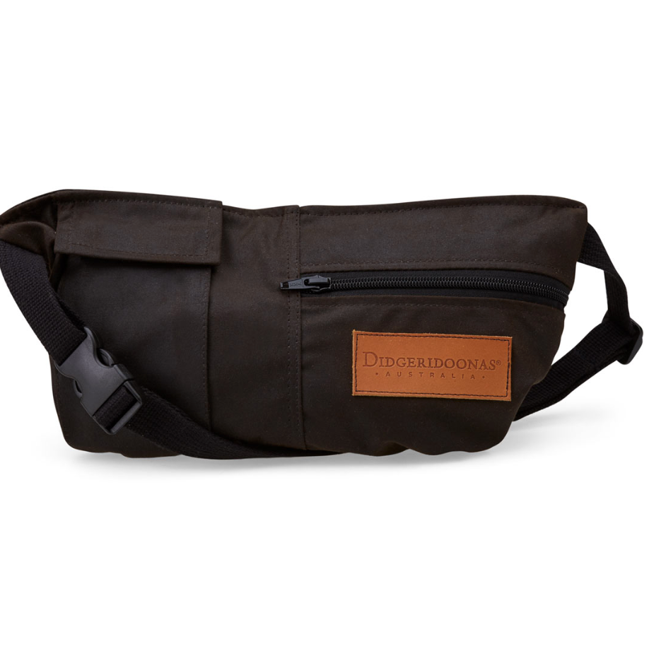 A dark brown crossbody fanny pack with a brown leather brand patch on the front, shown on a clean white background.