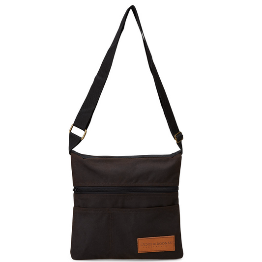A black nylon shoulder bag with a wide adjustable strap, a top zipper, and a brown leather brand patch on the front pocket, shown against a plain white background.