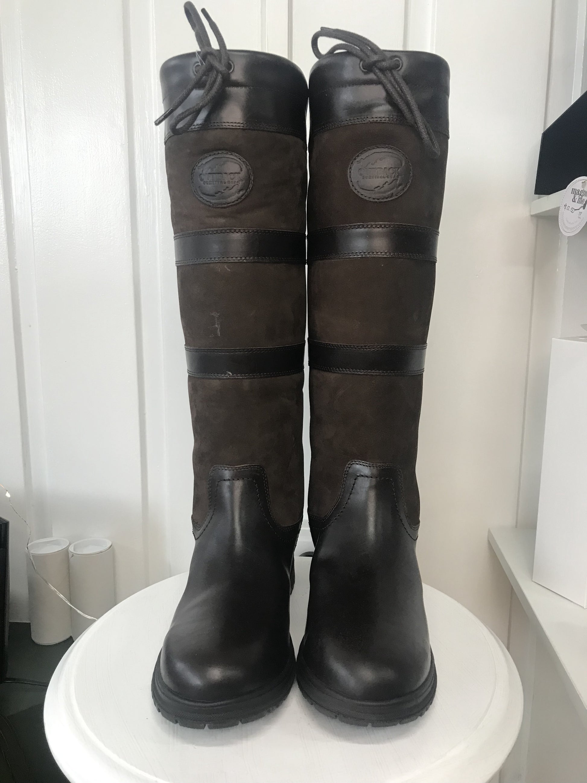 A pair of brown, waterproof boots with a lace-up closure and a steel shank, displayed against a white background.