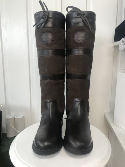 A pair of brown, waterproof boots with a lace-up closure and a steel shank, displayed against a white background.